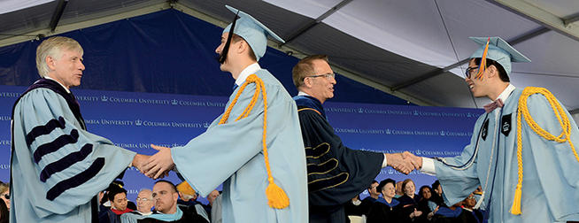 President Lee C. Bollinger and Dean James J. Valentini offer congratulations to members of the Class of 2015. PHOTO: EILEEN BARROSO